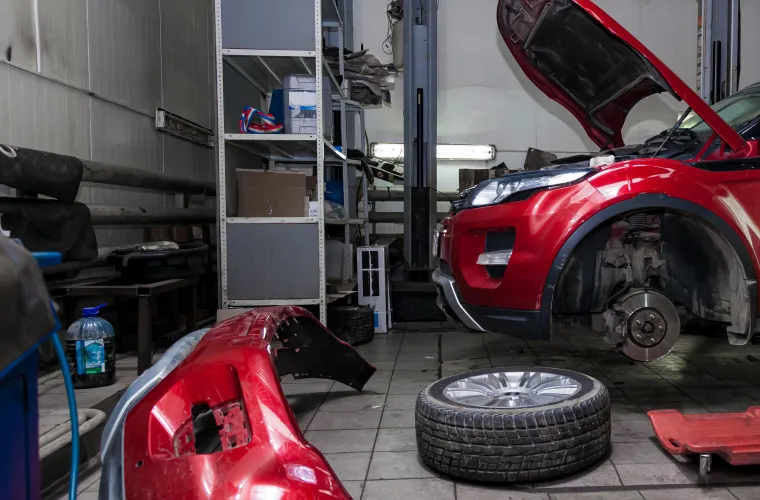 Red car being repaired in garage at Pristine Motorsports in 950 S Dupont Blvd, Smyrna, DE.