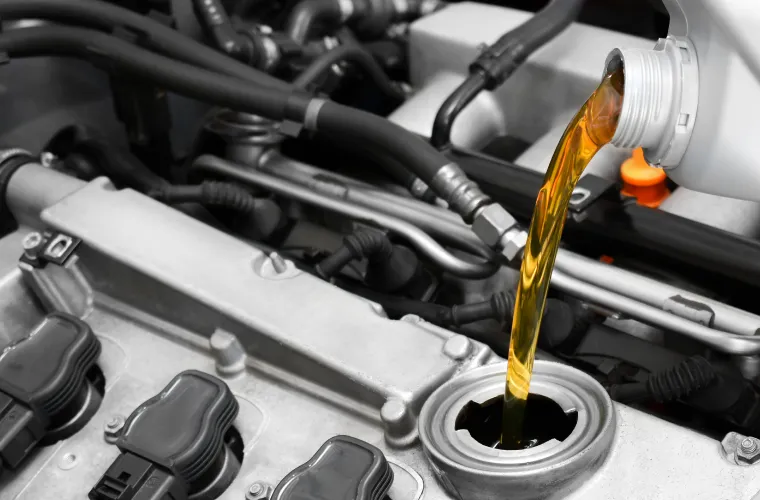 Mechanic pouring oil into an engine at Pristine Motorsports in 950 S Dupont Blvd, Smyrna, DE.