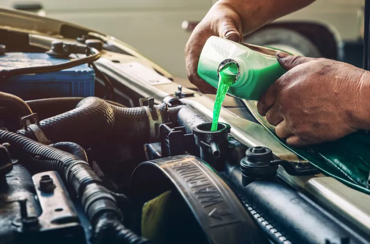 Mechanic changing radiator fluid at Pristine Motorsports in 950 S Dupont Blvd, Smyrna, DE.