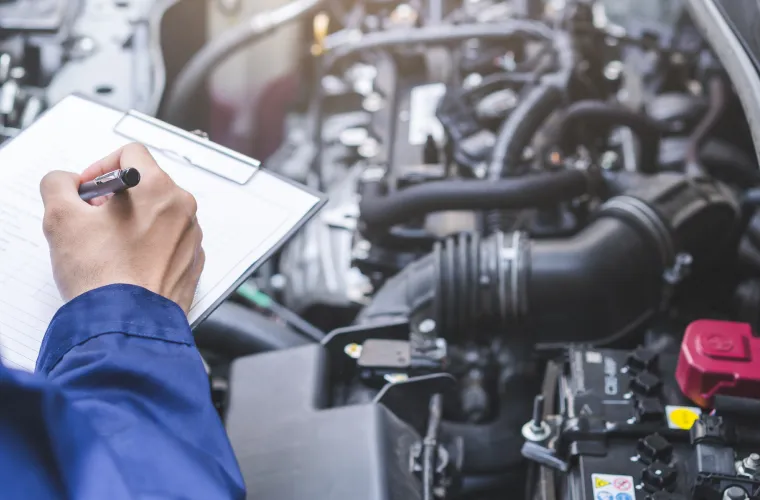 Mechanic inspecting engine with clipboard at Pristine Motorsports in 950 S Dupont Blvd, Smyrna, DE.