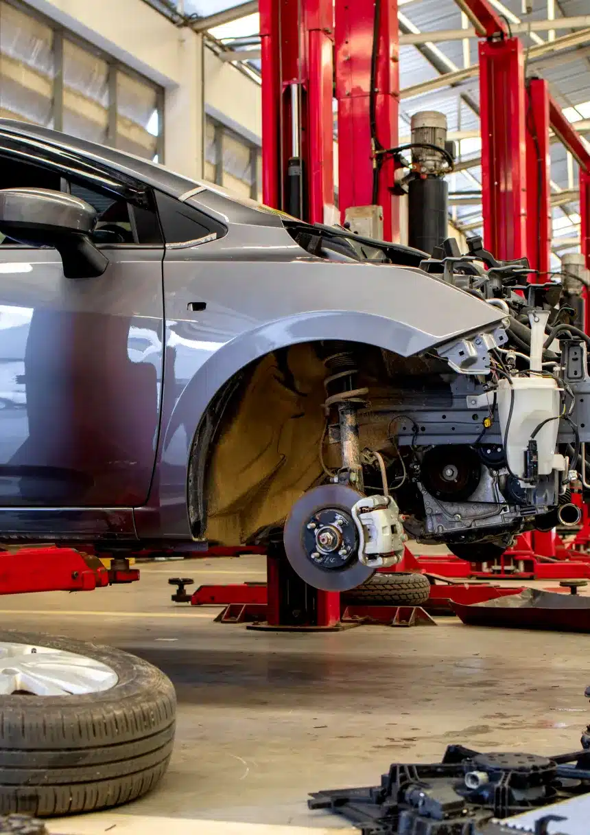 Auto Repair by Pristine Motorsports in 950 S Dupont Blvd, Smyrna, DE shown by an image of a car on lift, partially disassembled.